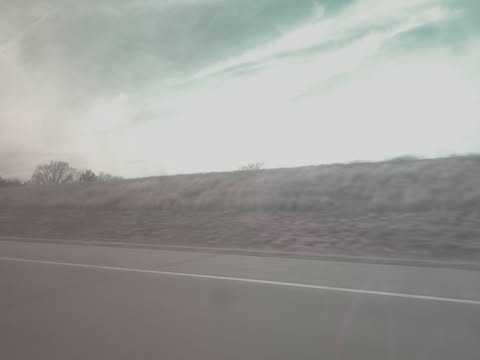A hazy highway shot with a teal sky and motion blur