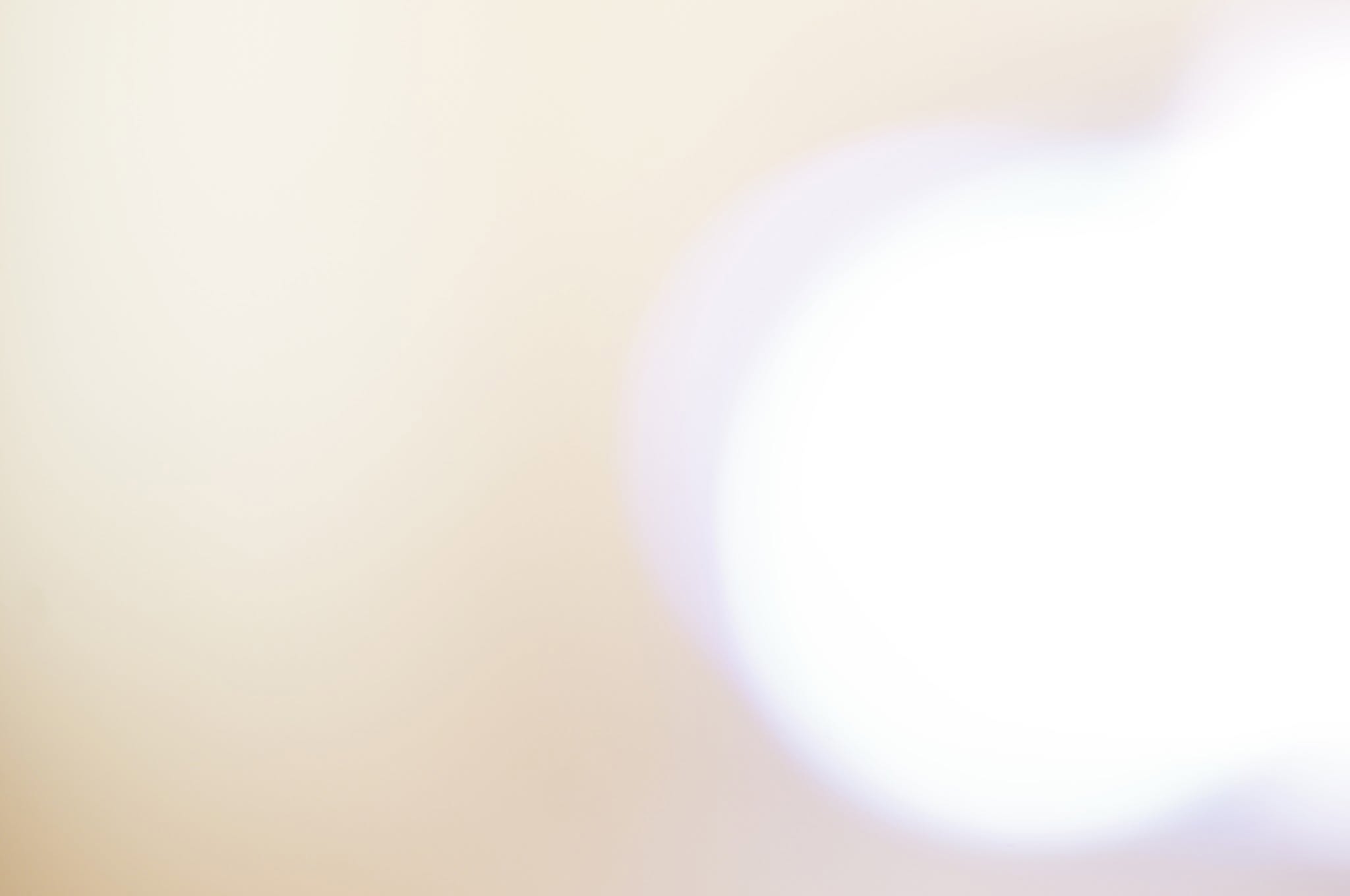 A glowing white and violet abstract orb of light